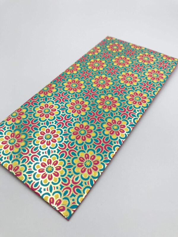 A sample of decorative paper showcasing intricate gold foil printing that outlines a vibrant, repeating floral pattern in pink, yellow, and teal, creating a luxurious and detailed finish.