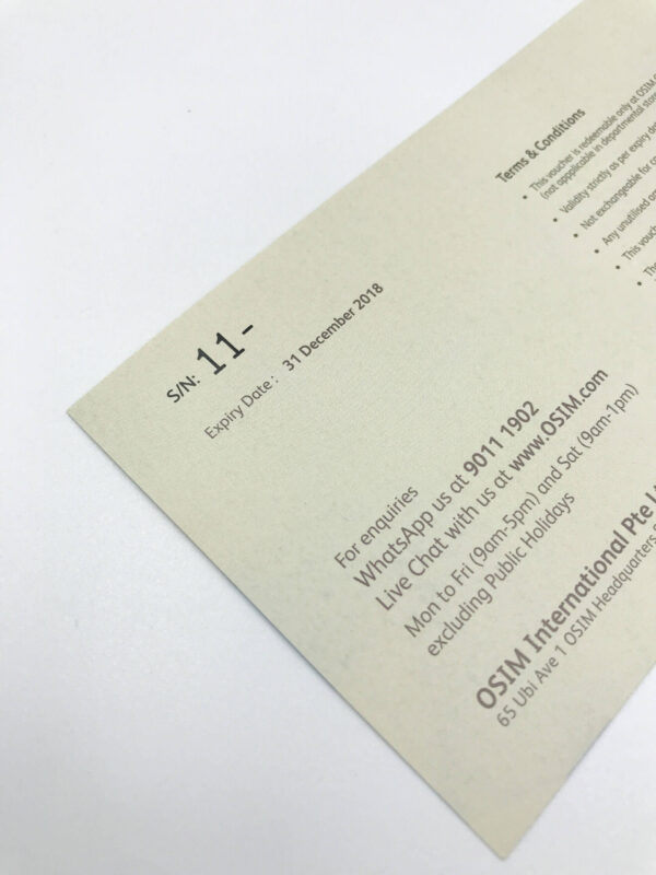 A close-up of the back of a voucher demonstrating variable data printing, with a unique serial number (S/N: 11-) printed alongside the terms and conditions and contact information for OSIM.