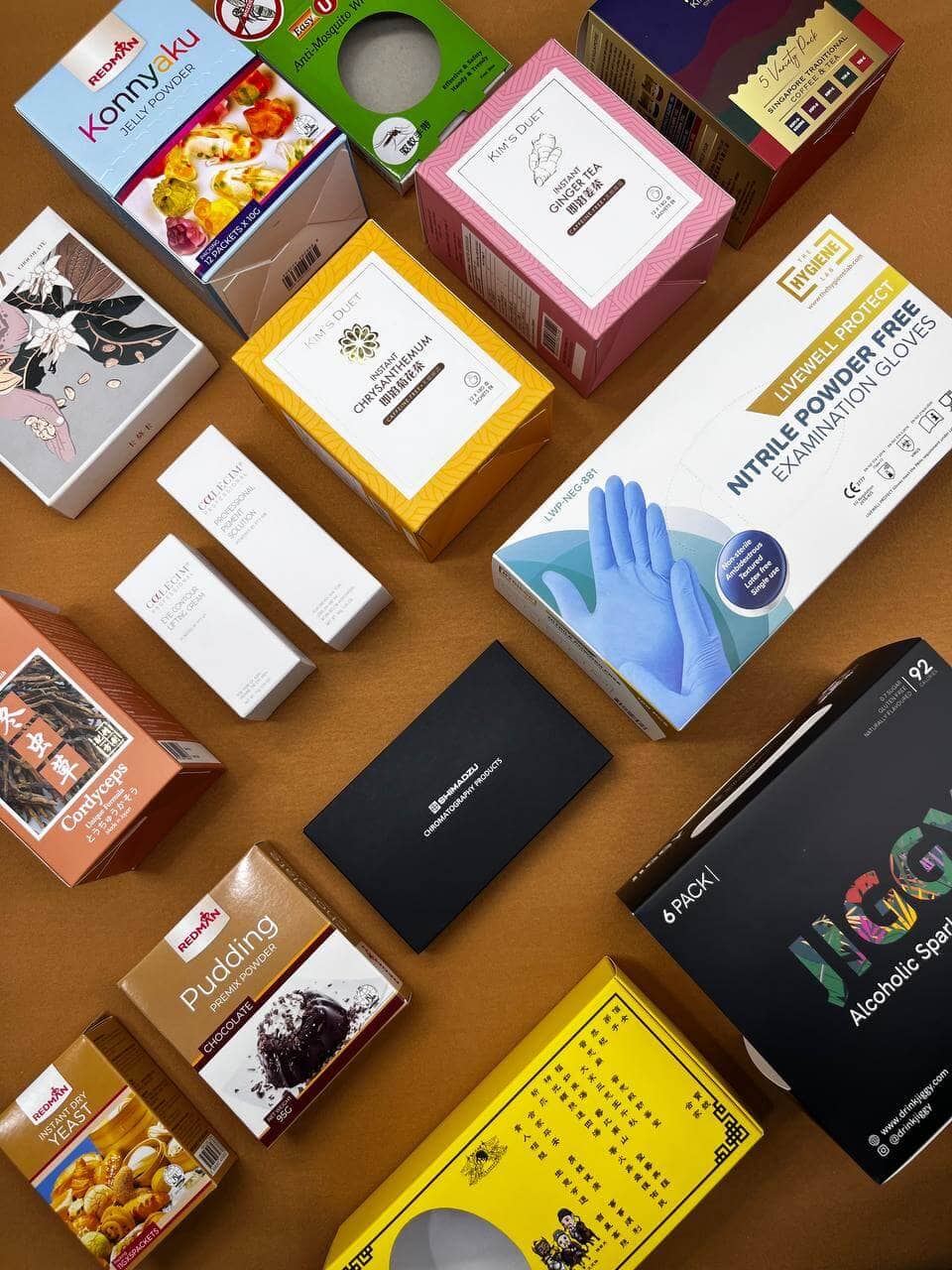 An array of professionally printed commercial product boxes, demonstrating a printing company's capability to produce high-quality, branded packaging for a diverse range of consumer goods.