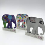 Three custom-printed and die-cut elephant figures, each with a unique artistic design, created as promotional items for the ION Orchard Elephant Parade event.