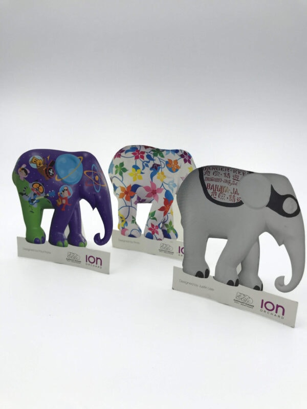 Three custom-printed and die-cut elephant figures, each with a unique artistic design, created as promotional items for the ION Orchard Elephant Parade event.