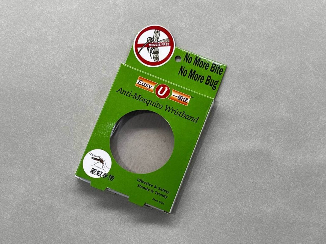 The green retail packaging for an Easy U Anti-Mosquito Wristband, featuring a custom die-cut window to display the product