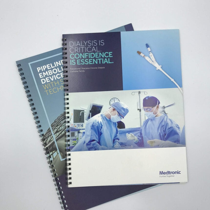 Two spiral-bound corporate brochures for Medtronic, a medical technology company, featuring high-quality images of medical procedures and devices on their covers