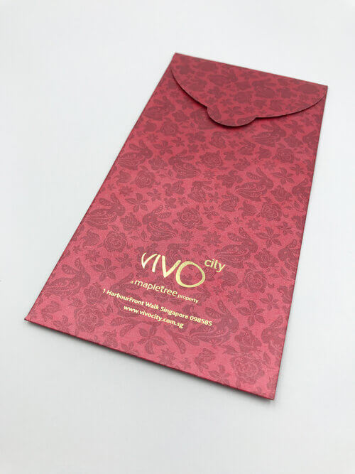 The back of a custom-printed red packet for VivoCity, showcasing a subtle tonal pattern of rabbits and flowers and the corporate logo stamped in gold foil