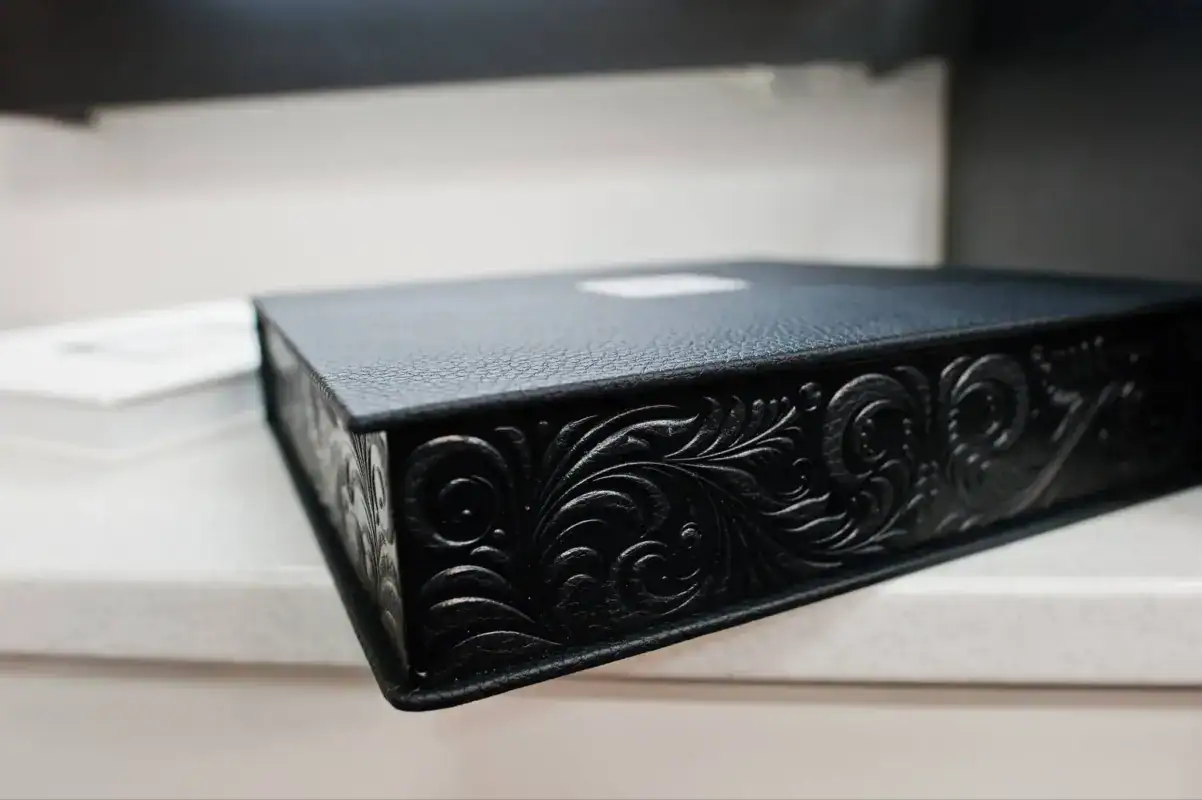 Black luxury box with debossed floral scroll pattern