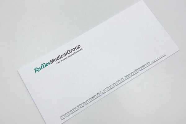 A professionally printed DL business envelope for Raffles Medical Group
