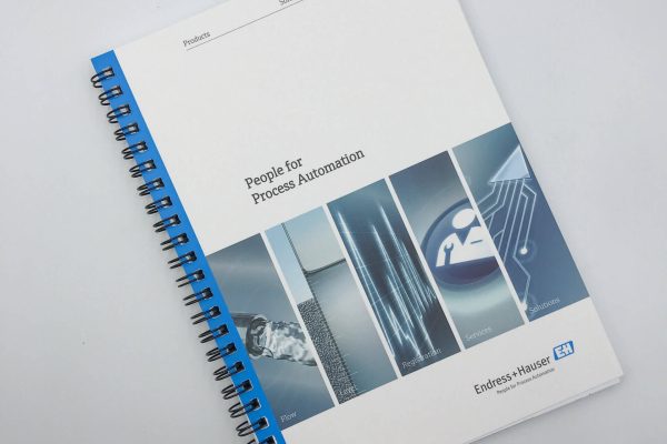 The cover of a professionally printed, spiral-bound corporate manual for Endress+Hauser, titled 'People for Process Automation', on a white background.