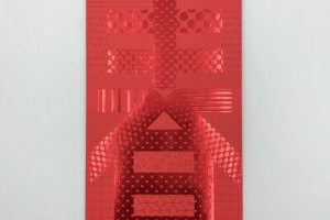 A striking red envelope showcasing an intricate use of red foil printing to create the character 'Spring' (春) with a patchwork of different glossy, geometric, and polka-dot patterns.